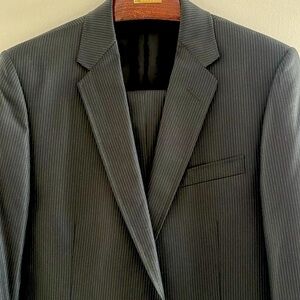 Gucci two button slim suit, single vent, black with fine pinstripe. 50R.
